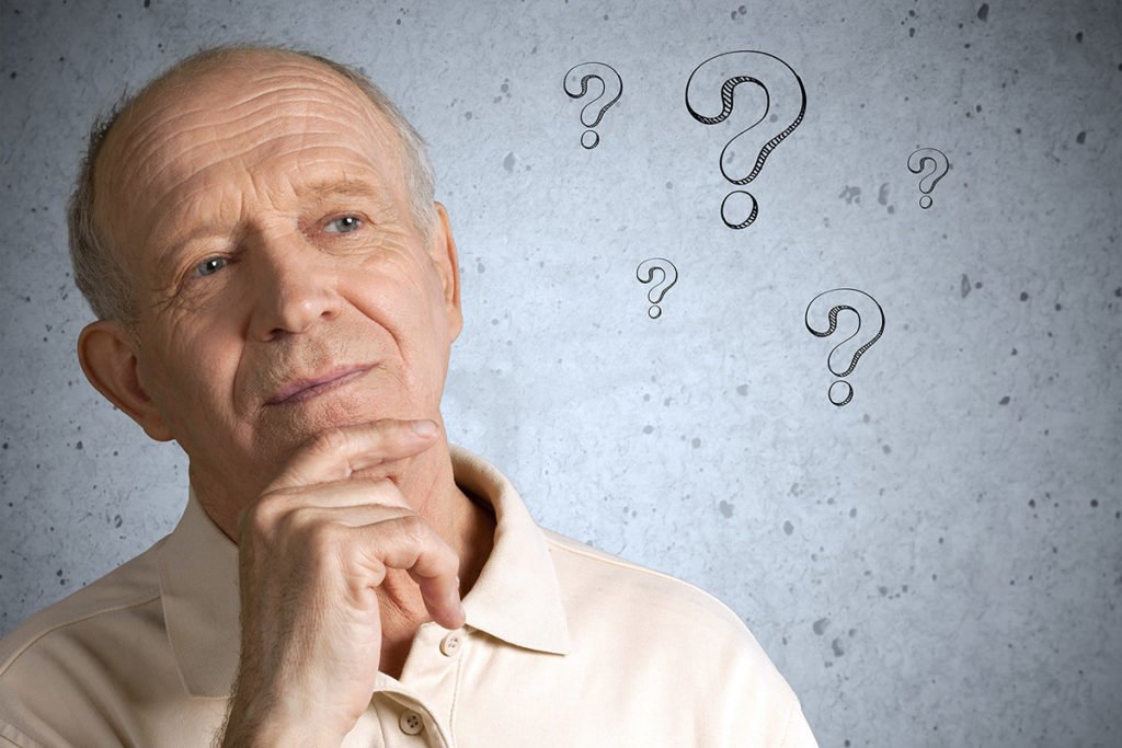 Older man with hand on chin thinking